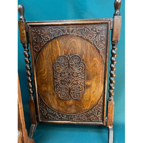 327A - Two 1920's /30's oak framed fire screens, one with embossed leather heraldic panel depicting a griff... 