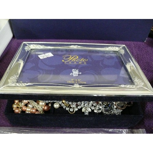 121 - A SILVER PLATE PHOTO FRAME JEWELLERY BOX WITH CONTENTS OF COSTUME JEWELLERY.