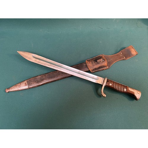 216 - A good WW1 German bayonet with 2 piece wooden grip. Original leather and steel mounted scabbard with... 