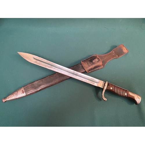 216 - A good WW1 German bayonet with 2 piece wooden grip. Original leather and steel mounted scabbard with... 