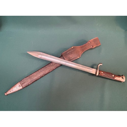 216 - A good WW1 German bayonet with 2 piece wooden grip. Original leather and steel mounted scabbard with... 