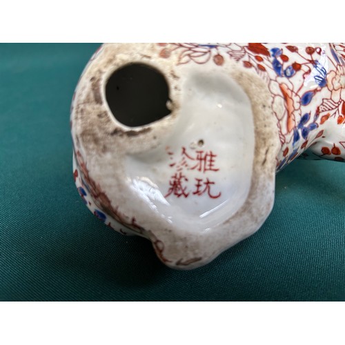 15 - An imari palette porcelain pig with 4 character mark to base.  Decorated in a vase and flower design... 