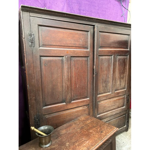 351 - A very large antique oak Housekeepers cupboard from a Norfolk country house. The doors each with fou... 