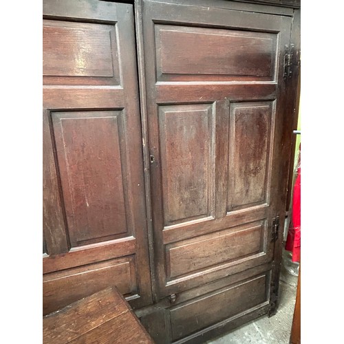 351 - A very large antique oak Housekeepers cupboard from a Norfolk country house. The doors each with fou... 