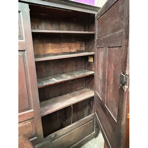 351 - A very large antique oak Housekeepers cupboard from a Norfolk country house. The doors each with fou... 