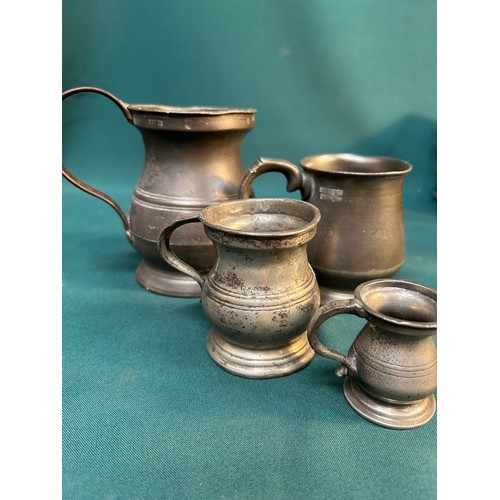 325C - Four 19th Century pewter tankards & measures including a pint tankard by James Yates with VR cypher,... 