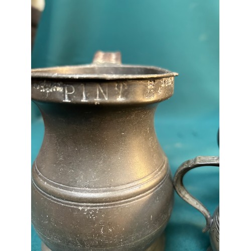 325C - Four 19th Century pewter tankards & measures including a pint tankard by James Yates with VR cypher,... 