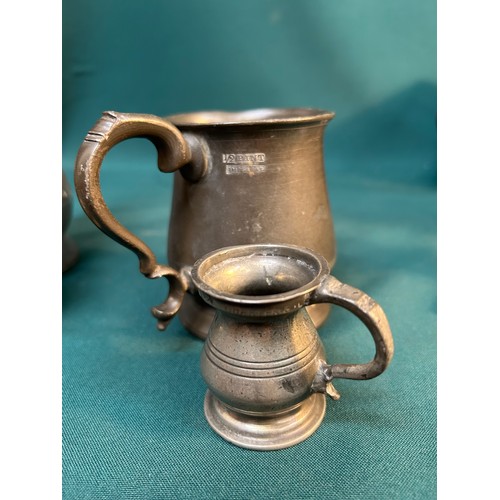 325C - Four 19th Century pewter tankards & measures including a pint tankard by James Yates with VR cypher,... 