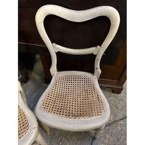 377 - Pair of Victorian balloon back chairs with canework seats, painted in a stone colour