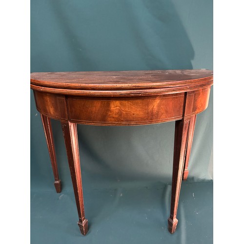 392 - A Georgian demi lune tea table on tapered legs terminating in spade feet. From a Norfolk country hou... 