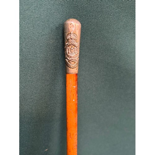 208 - A Suffolk Regiment swagger stick - 68cm long with malacca cane and metal tip.