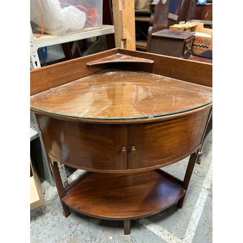 389 - Edwardian mahogany bow fronted corner washstand with glass top and upstand with small shelf