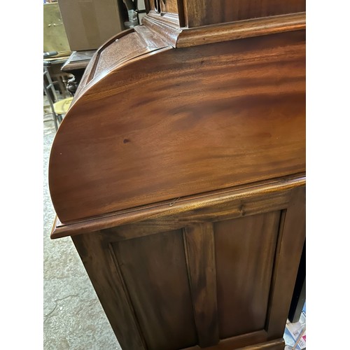 404 - Reproduction mahogany writing bureau with cylinder top enclosing drawer and pigeon holes, over a wri... 