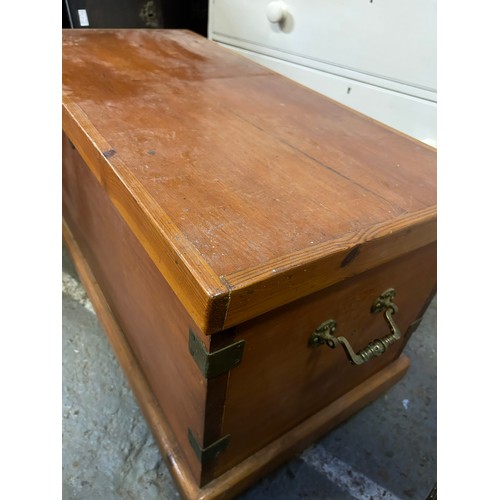 406 - An Antique Pine blanket chest with ornate brass handles and reinforced corners, with internal candle... 