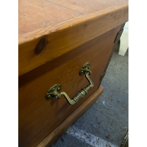 406 - An Antique Pine blanket chest with ornate brass handles and reinforced corners, with internal candle... 