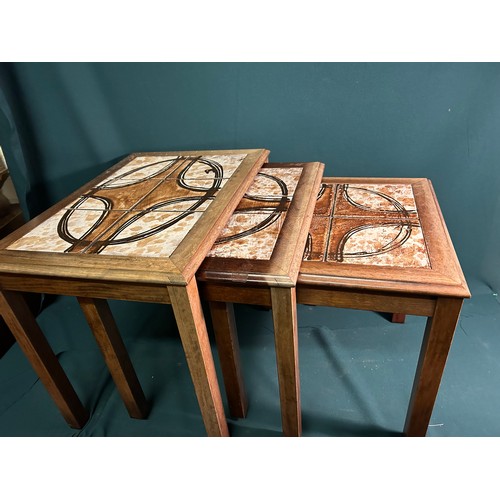 331 - A 1970's Danish nest of 3 tables with tile tops. Fading to the wood, tiles in good condition.