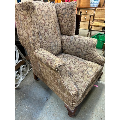 354 - Early 20th Century wing back armchair on short cabriole legs with original brass castors. Upholstere... 