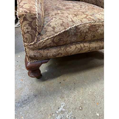 354 - Early 20th Century wing back armchair on short cabriole legs with original brass castors. Upholstere... 