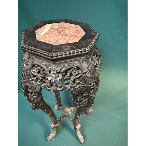 342 - An Antique Chinese jardiniere stand in ornately carved hardwood, the octagonal top with marble inser... 