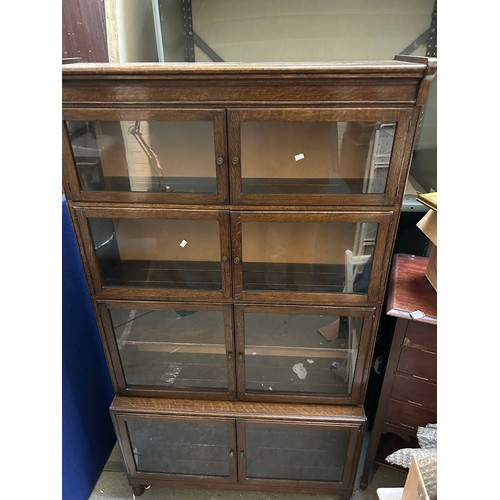 332 - A 1940's Globe Wernicke style oak bookcase. Unlike the Wernicke, the doors are side hinged and the b... 