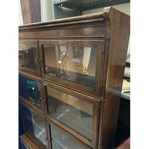 332 - A 1940's Globe Wernicke style oak bookcase. Unlike the Wernicke, the doors are side hinged and the b... 