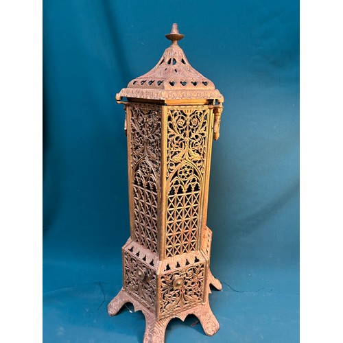 329 - An Antique Cast iron gas or paraffin heater surround in Gothic style, three sides with red glass pan... 