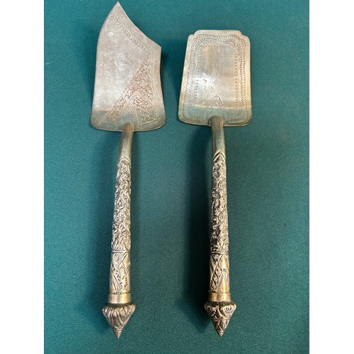 148 - Pair of 20th Century silver metal servers / slices with ornate embossed handles. Probably Thai / Far... 