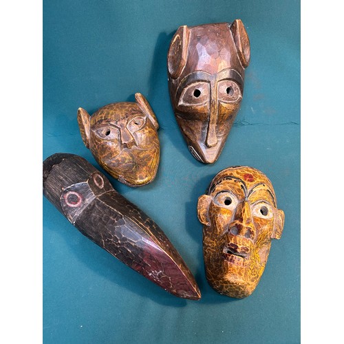 131B - Collection of four hand made wooden masks from world travels