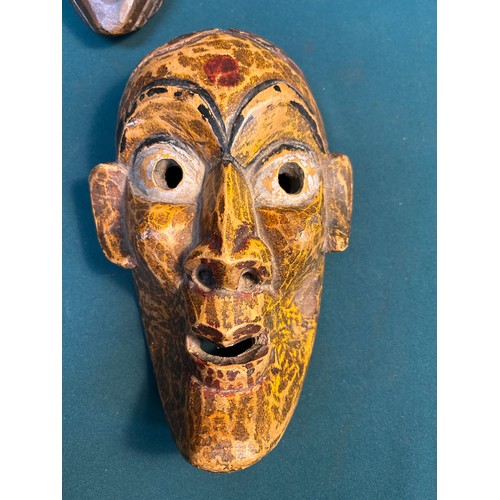 131B - Collection of four hand made wooden masks from world travels