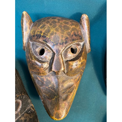 131B - Collection of four hand made wooden masks from world travels