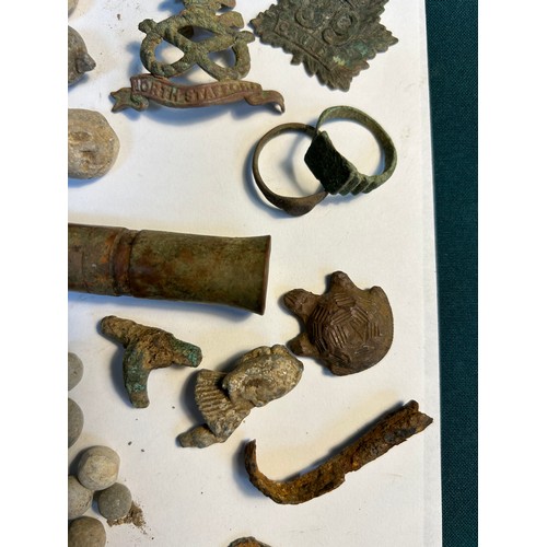 Metal detecting finds including lead musket balls, toy soldier, turtle ...