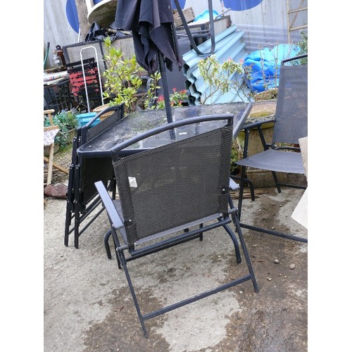 389 - SQUARE GLASS GARDEN TABLE WITH FOUR MATCHING CHAIRS AND PARASOL