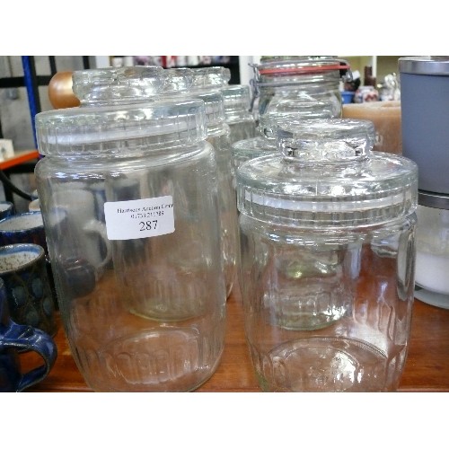 287 - 4 LARGE GLASS CANNISTERS WITH SUCTION LIDS, 3 SMALLER MATCHING ONES AND ONE OTHER.