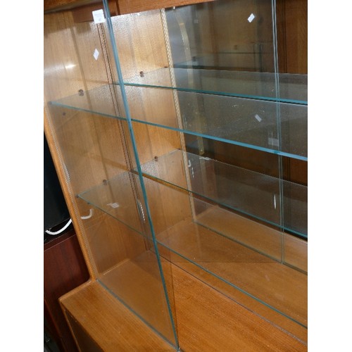 487 - TEAK MID CENTURY DISPLAY CABINET, 2 LOWER CUPBOARDS AND UPPER GLASS DOOR WITH GLASS SHELVES.