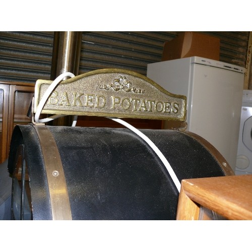 488 - THE COTSWOLD BAKED POTATO OVEN IN BLACK METAL WITH BRASS ADORNMENTS.