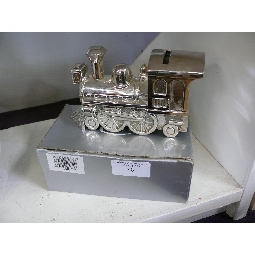 88 - A DECORATIVE BOXED SILVER PLATE TRAIN MONEY BOX