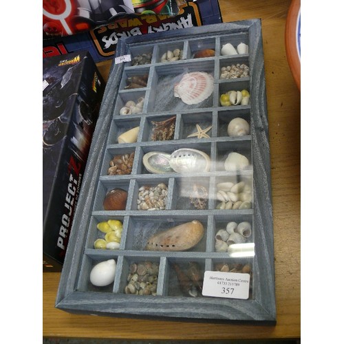 357 - A WALL HANGING DISPLAY CASE AND A TALL GLASS JAR WITH CONTENTS OF DECORATIVE SHELLS.