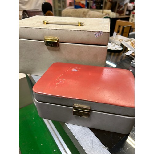 50A - TWO JEWELLERY CASES, ONE IN GREY AND RED LEATHER, TH OTHER WITH MULTIPLE DRAWERS AND COMPARTMENTS