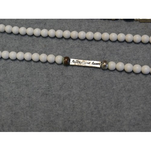 42 - ETHNIC STYLE LONG WHITE BEADED NECKLACE WITH INTERMITTENT METAL BARS WITH IMPRINTED 'FOLLOW YOUR HEA... 