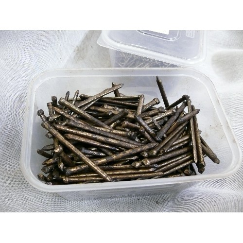 218 - A SELECTION OF VARIOUS TUBS OF NAILS