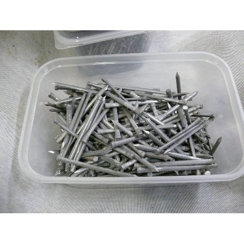 218 - A SELECTION OF VARIOUS TUBS OF NAILS