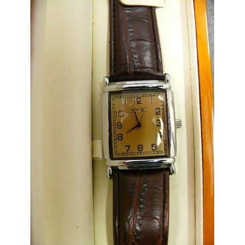 19 - A VINTAGE EYKI WATCH WITH BROWN STRAP