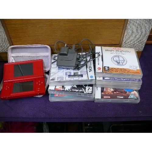 46A - A RED NINTENDO DSLITE IN A BABY PINK CASE WITH CHARGER AND VARIOUS GAMES TO INCLUDE RATATOUILLE, STO... 