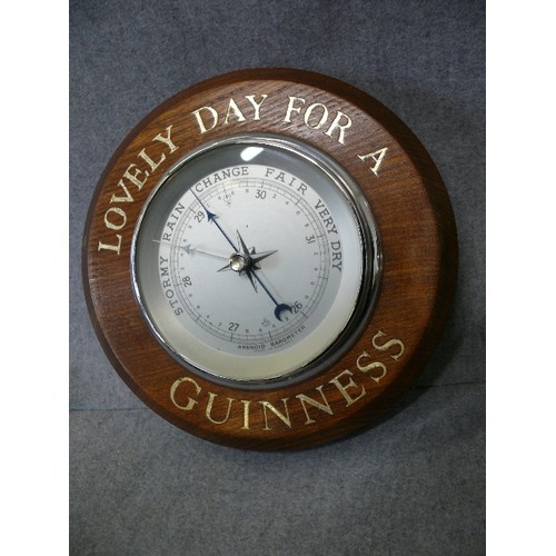 158 - A WOODEN CASED ANEROID BAROMETER WITH 'LOVELY DAY FOR A GUINNESS' MOTIF