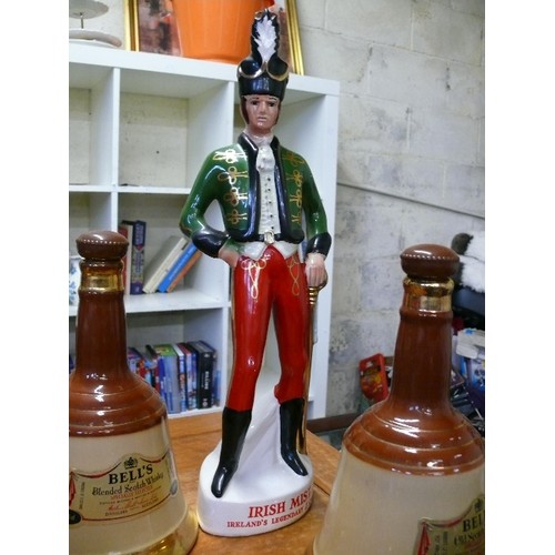 235 - AN IRISH MIST IRELAND'S LEGENDARY LIQUEUR SOLDIER DECANTER PLUS 3 BELLS WHISKY DECANTERS