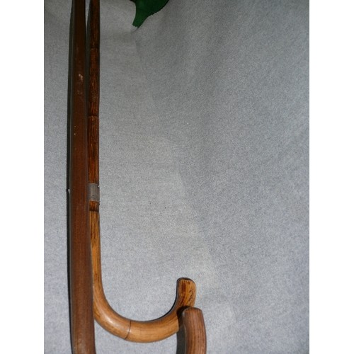 210 - TWO VINTAGE WALKING STICKS, ONE WITH A POSSIBLY SILVER COLLAR