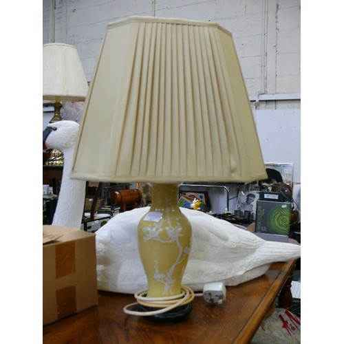 275 - TABLE LAMP WITH MUSTARD COLOUR BASE ADORNED WITH WHITE BIRDS AN A CREAM PLEATED SHADE