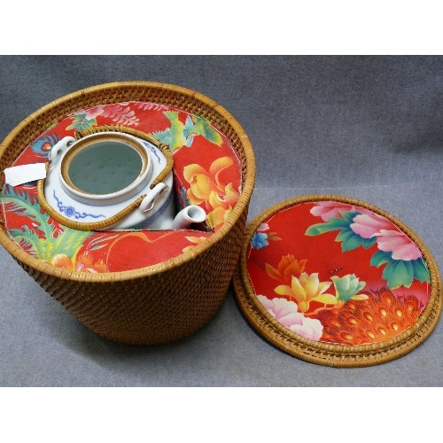 60 - A FITTED WICKER BASKET WITH CONTENTS OF A CHINESE TEAPOT (NO LID)