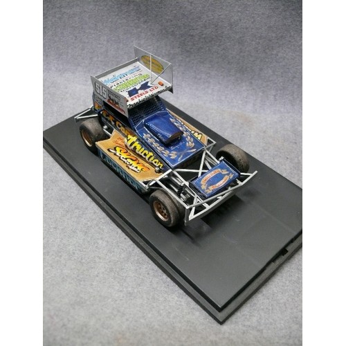 A FORMULA 1 STOCK CAR MODEL IN DISPLAY CASE