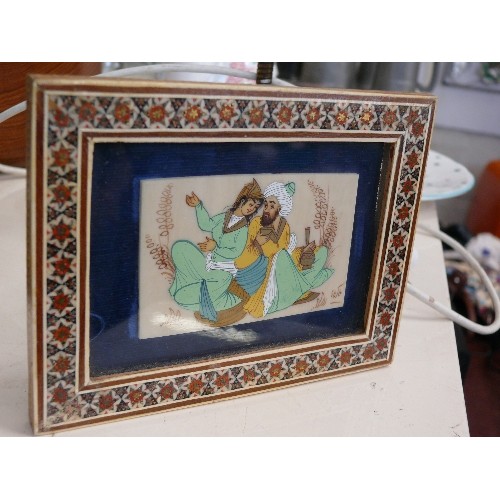 25 - A MINIATURE PERSIAN SIGNED PAINTING ON PORCELAIN IN A WOODEN INLAID MOSAIC FRAME